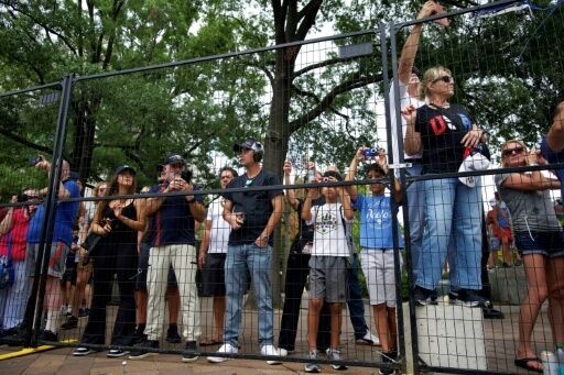 Spectators line the track to watch IndyCars during a practice session for the Freedom 250 Grand Prix in Washington